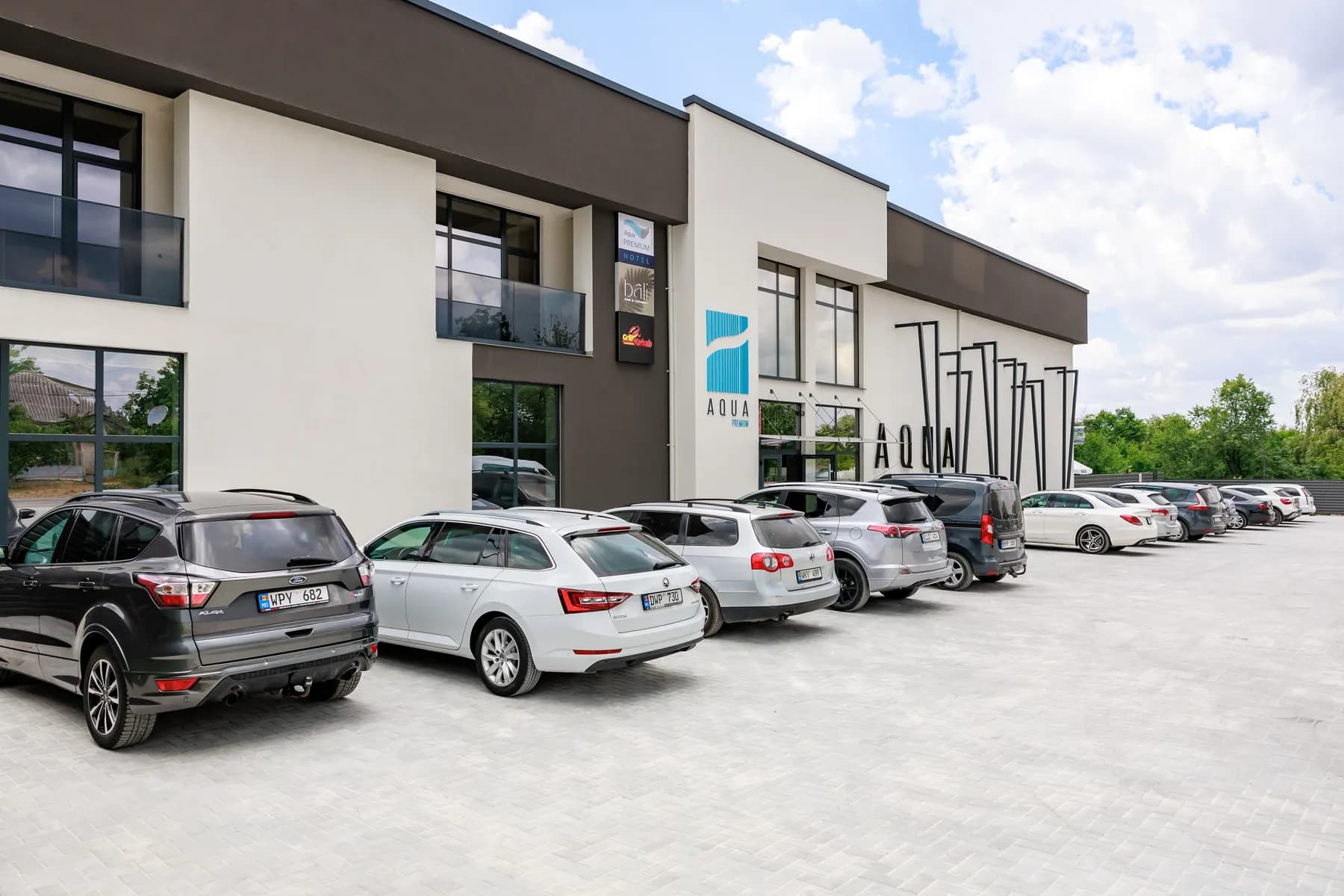AquaPremium Hotel exterior within the park setting
